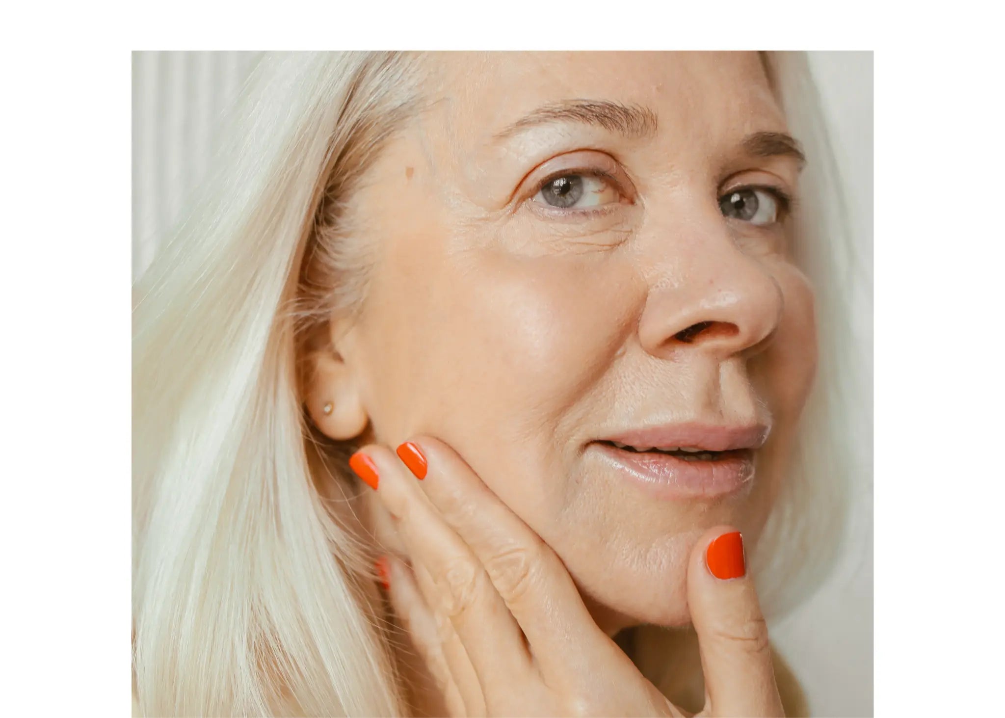 Woman with white hair touching her jawline with hand