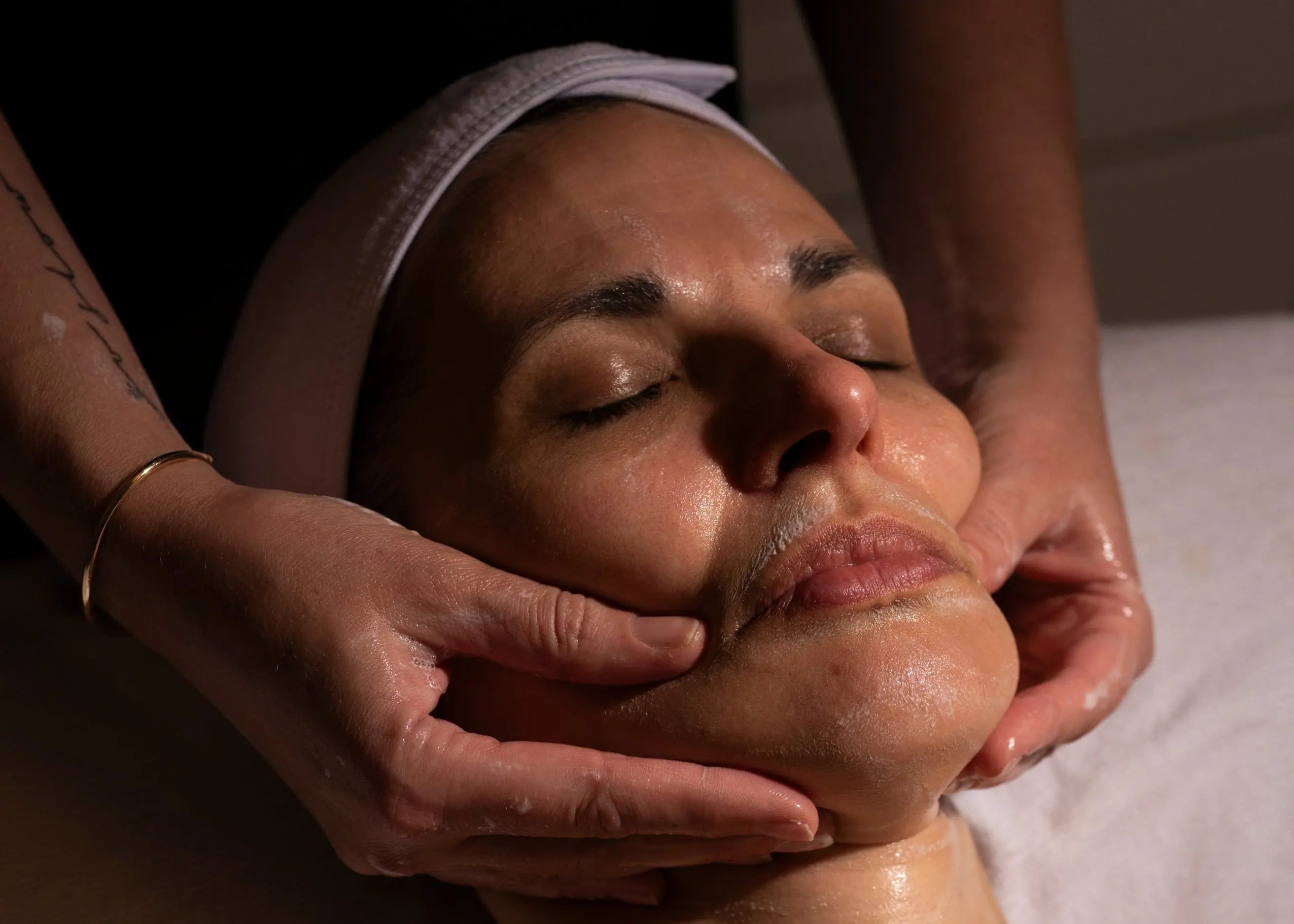 Woman receiving facial massage