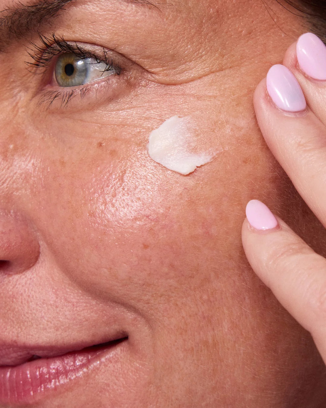Woman applying face cream