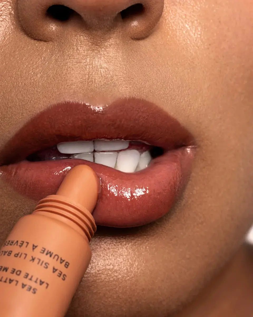 Women applying Sea Latte Mara lip balm