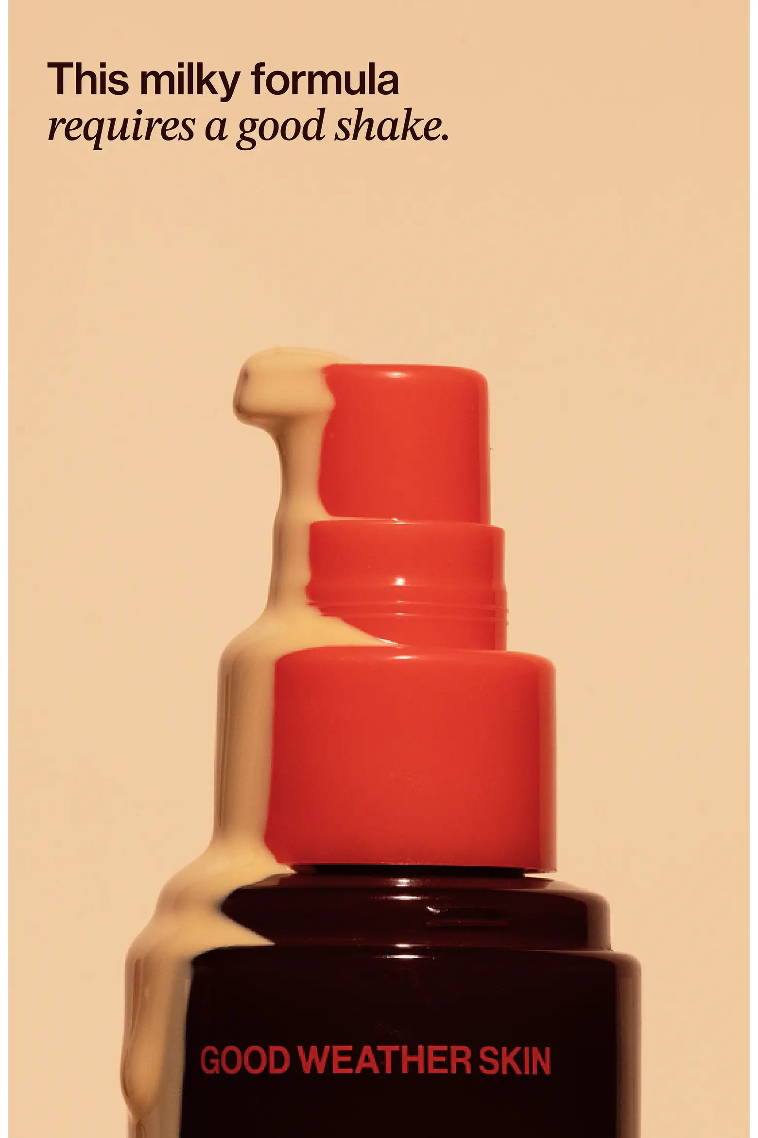 Bottle of 'Good Weather Skin' with a red pump and beige liquid, on a beige background.